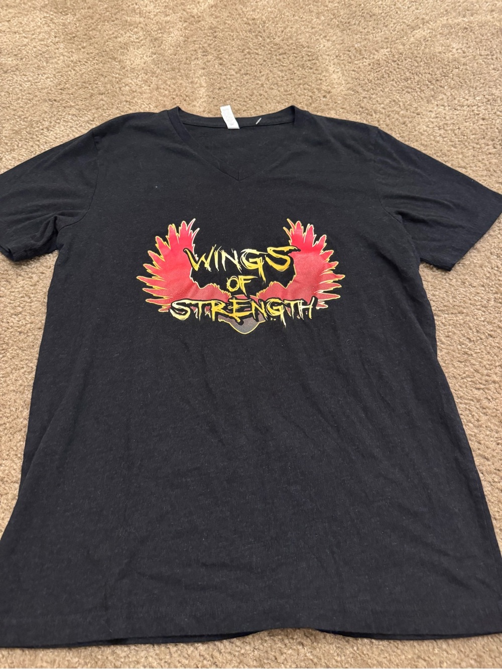 Bella Canvas Black Graphic Tee with Red Wings and Yellow Lettering